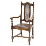 A VICTORIAN CARVED AND TURNED OAK ELBOW CHAIR WITH SCROLLING ARMS