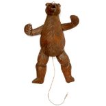 A SWISS CARVED AND STAINED WOOD 'BLACK FOREST' PULL STRING HANGING BEAR, WITH BLACK GLASS BOOT