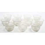 A SET OF ELEVEN CUT GLASS THISTLE SHAPED FINGER BOWLS, ENGRAVED WITH A BORDER OF THISTLES, 13CM D,