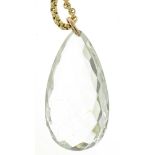 A PEAR SHAPED ROCK CRYSTAL PENDANT ON A GOLD COLOURED METAL CHAIN WITH A GOLD PLATED CLASP, CHAIN