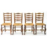 A SET OF FOUR VICTORIAN ASH LADDER BACK RUSH SEATED DINING CHAIRS