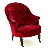 A VICTORIAN EBONISED ARMCHAIR, UPHOLSTERED IN RED BUTTON BACK FABRIC