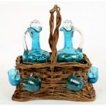 A PAIR OF VICTORIAN KING FISHER BLUE GLASS LIQUEUR CARAFES AND STOPPERS WITH FOUR CUPS EN SUITE,