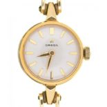 AN OMEGA GOLD PLATED LADY'S WRISTWATCH, ON GOLD STRAP MARKED 585, 1.8 CM DIAMETER, CASED++LIGHT WEAR