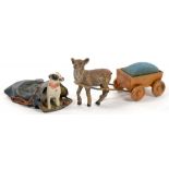 TWO MINIATURE COLD PAINTED BRONZE ANIMALS ONE A DOG IN A SACK, THE OTHER A DOG AND CART