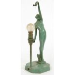 AN ART DECO GREEN PAINTED SPELTER TABLE LAMP IN THE FORM OF A NAKED YOUNG WOMAN ON TIPTOE, 38CM H,