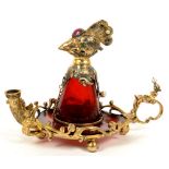 AN UNUSUAL CONTINENTAL JEWELLED GILTMETAL MOUNTED RUBY GLASS INKWELL IN THE FORM OF A BIRD WITH