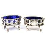 A PAIR OF EDWARD VII PIERCED SILVER SALT CELLARS, BLUE GLASS LINERS, 4 CM H, LONDON 1905, 2OZS++