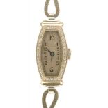 A BUCHERER DIAMOND TONNEAU COCKTAIL WATCH, C1930, IN WHITE GOLD MARKED 14C, ON PLATED BRACELET++