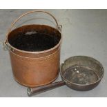 A VICTORIAN COPPER FRYING PAN WITH TUBULAR HANDLE, 28CM D AND A RIVETED COPPER COAL BUCKET WITH