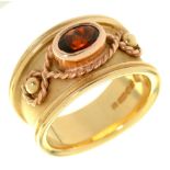 WELSH GOLD. A 9CT GOLD B AND, SET WITH AN OVAL GARNET, MAKER CD, St above, dragon mark, Sheffield