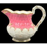 A ROCKINGHAM PINK GROUND DAISY MOULDED JUG, 18.5CM H, PUCE PRINTED GRIFFIN MARK, C1830-42