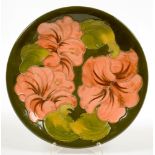 A MOORCROFT HIBISCUS PLATE, 25.5CM D, IMPRESSED MARKS, GREEN PAINTED INITIALS