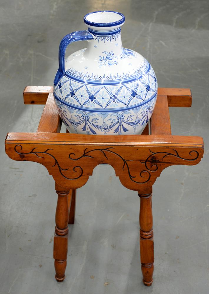 A BLUE AND WHITE OIL JAR ON CARVED WOOD STAND