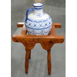 A BLUE AND WHITE OIL JAR ON CARVED WOOD STAND