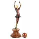 AN ART DECO PATINATED IVORINE STATUETTE IN THE FORM OF AN EXOTIC DANCER, ON COMPOSITION SOCLE,