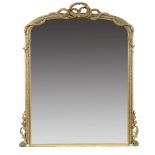 A VICTORIAN GILTWOOD AND COMPOSITION OVERMANTLE MIRROR, C1870, the low arched frame crested by a bow