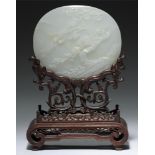 A CHINESE WHITE JADE PLAQUE, QING DYNASTY, 19TH C, of slightly convex form carved with phoenix and
