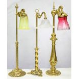 THREE DECORATIVE BRASS READING LAMPS AND COLOURED GLASS SHADES, VICTORIAN IN PART, 79CM H AND CIRCA