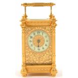 A FRENCH BRASS CARRIAGE CLOCK, THE TIMEPIECE WITH PRIMROSE ENAMEL CHAPTER RING AND PIERCED GILTMETAL