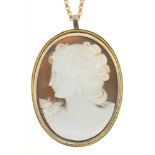 A SHELL CAMEO PENDANT BROOCH IN SILVER AND GOLD, ON GOLD CHAIN MARKED 9CT, CAMEO 30 MM L APPROX++