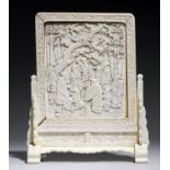 A FINE JAPANESE IVORY TABLE SCREEN, MEIJI PERIOD   carved with a group of Karako boys  riding a
