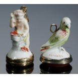 TWO CHELSEA PORCELAIN TOYS, C1756-8  one in the form of Cupid at an anvil, the other a green bird,