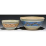 TWO MOCHA WARE BOWLS, MID 19TH C  decorated with a multichambered slip pot with bands of cat's