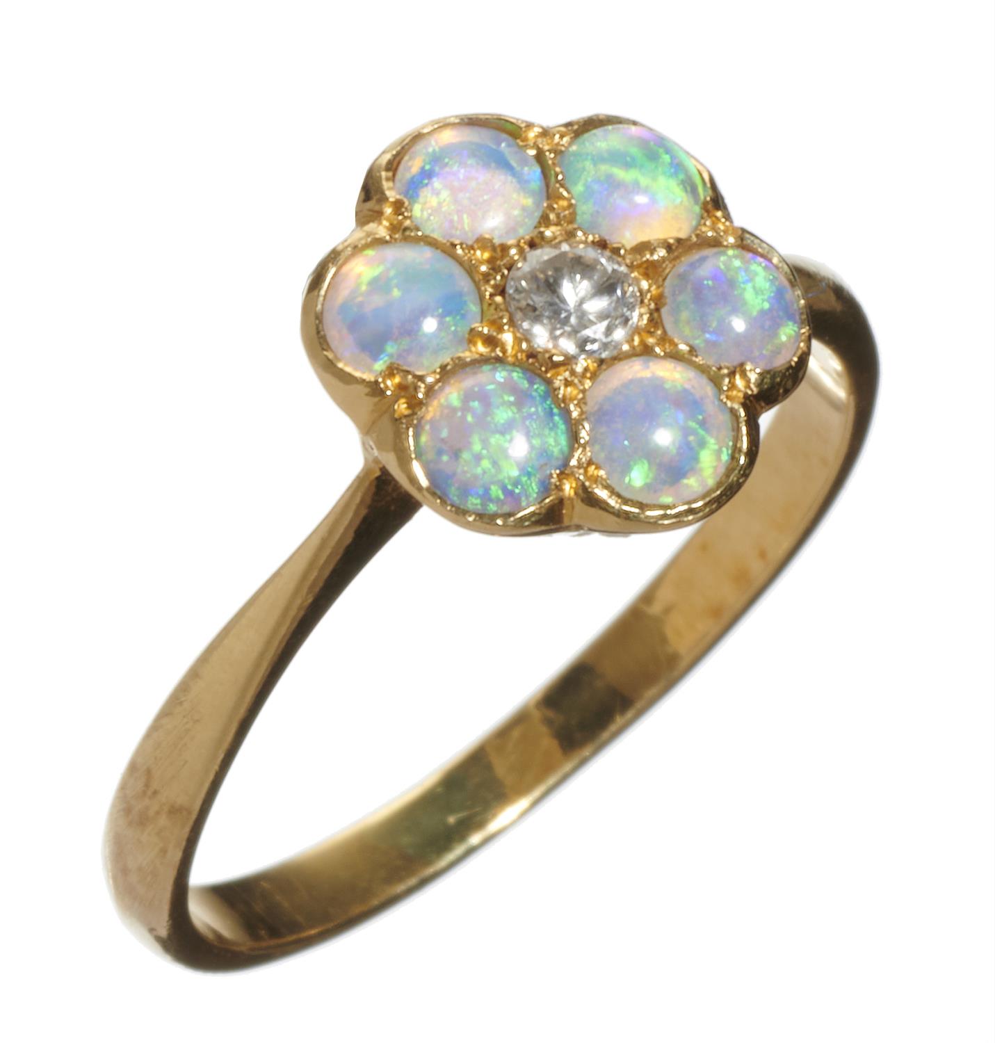 AN OPAL AND DIAMOND CLUSTER RING  in gold marked 18ct, 2.4g, size L½ Good condition, opals well