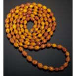 A NECKLACE OF ONE HUNDRED AND TWENTY THREE AMBER BEADS 67g Good condition