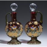 A PAIR OF MOSER ENAMELLED AND GILT WRYTHEN FLUTED AND SHADED CRANBERRY GLASS DECANTERS, EARLY 20TH C