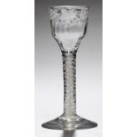 AN ENGLISH WINE GLASS, C1770  the fluted ogee bowl engraved with grapevines, on double series opaque