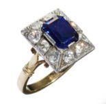 A SAPPHIRE AND DIAMOND CLUSTER RING  with larger step cut sapphire and surround of old cut diamonds,