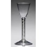AN ENGLISH WINE GLASS, C1760  the round funnel bowl on single series opaque twist stem, conical