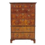 A GEORGE II WALNUT AND FEATHERBANDED CHEST ON CHEST, C1750 with cavetto cornice and three short