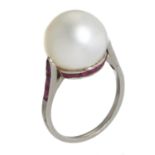 A RUBY AND CULTURED PEARL RING  the 1.1cm cultured pearl set in a girdle of calibre cut rubies