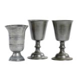 A PAIR OF SCOTTISH PEWTER COMMUNION CUPS, LATE 18TH C  22cm h and another with banded bell shaped