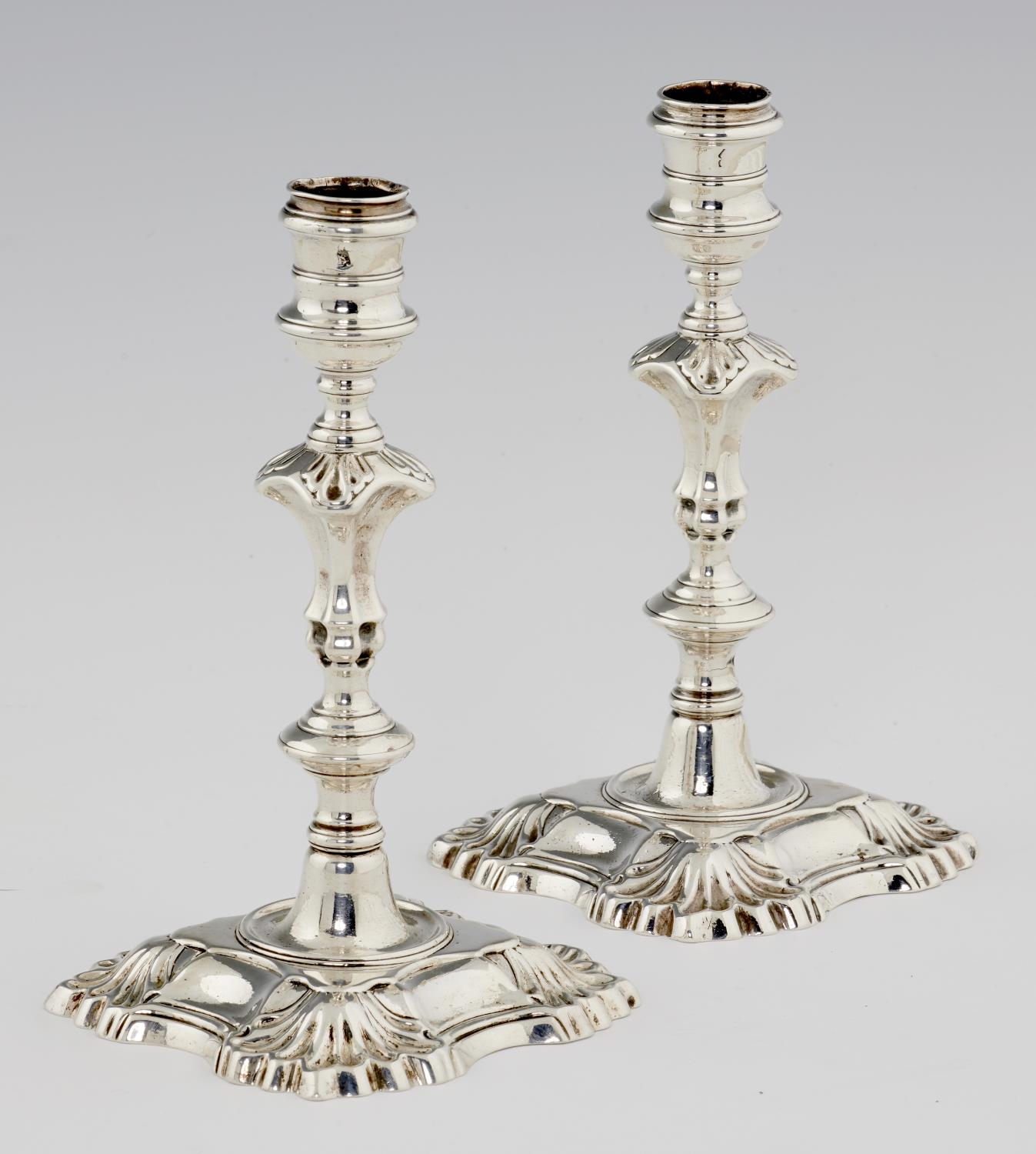 A PAIR OF GEORGE II SILVER CANDLESTICKS  on shell cornered foot, 19cm h, by Mary Gould (Mrs James