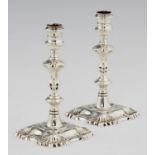 A PAIR OF GEORGE II SILVER CANDLESTICKS  on shell cornered foot, 19cm h, by Mary Gould (Mrs James