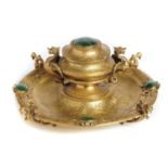 A VICTORIAN MALACHITE SET GILT BRASS INKWELL C1870 with winged grotesque handle and feet, 10cm h