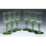 A SET OF SIX GREEN GLASS WINES, C1910 the fluted bucket bowl engraved with monogram and festoons,