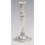 A GEORGE III NEO CLASSICAL SILVER CANDLESTICK  the flared foot applied with overlapping leaves,