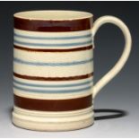 A CYLINDRICAL SLIP-DIPPED AND ENGINE TURNED CREAMWARE MUG, C1800-20 11.8cm h Good condition