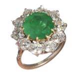 AN EMERALD AND DIAMOND CLUSTER RING  the emerald  in a surround of ten round brilliant cut diamonds,
