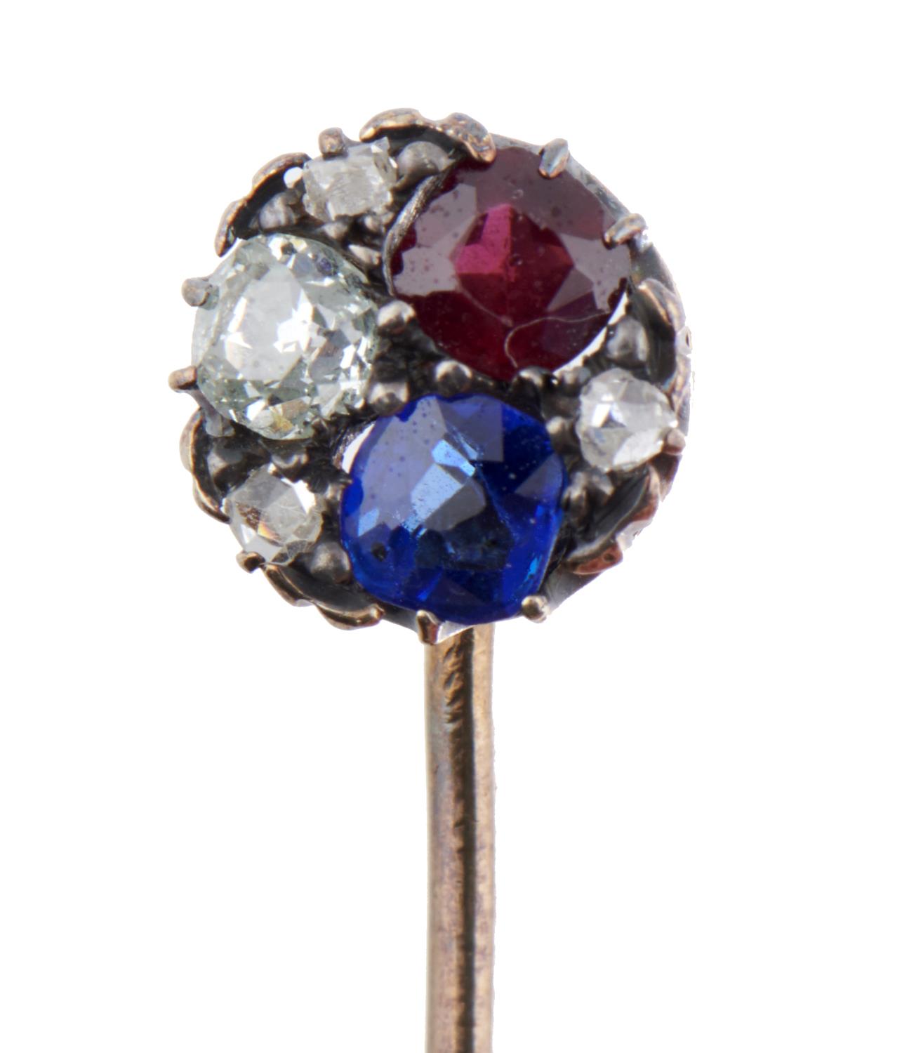 A GOLD STICKPIN, EARLY 20TH C   with diamond, ruby and sapphire terminal, head 0.8cm, 8cm, 2.8g Good