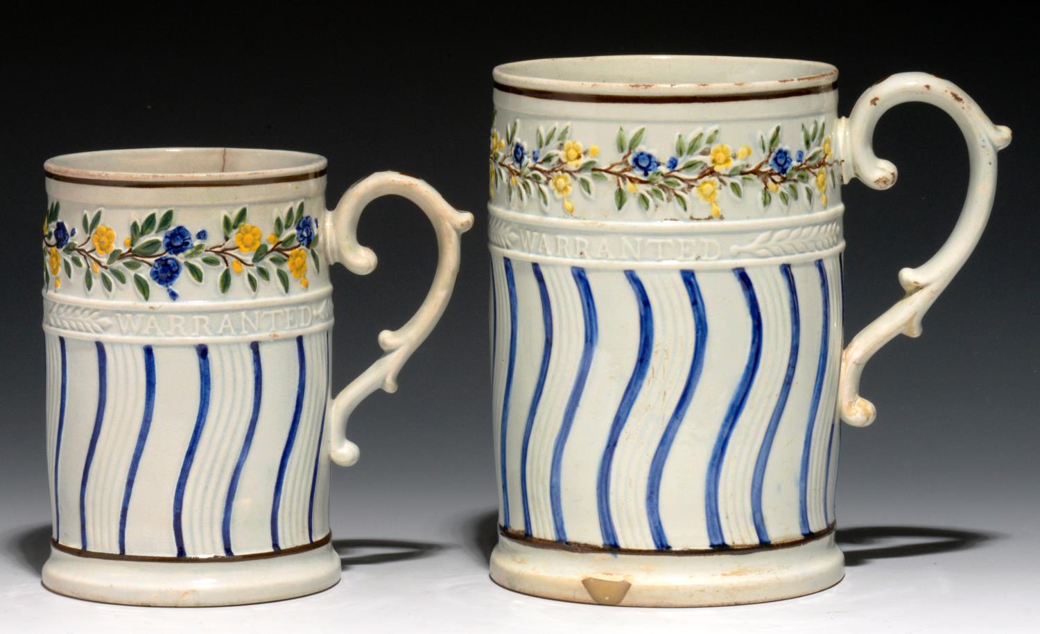 TWO GRADUATED CYLINDRICAL PRATT WARE WINCHESTER MEASURES, C1830 moulded with trailing flowers in a