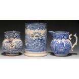 A CYLINDRICAL BLUE PRINTED EARTHENWARE MEASURE AND TWO JUGS, MID 19TH C  quart and pint, black