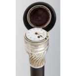 A FRENCH SILVER MOUNTED EBONISED GADGET CANE, EARLY 19TH C  the spirally reeded ogee pommel inset