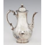 A VICTORIAN SILVER BALUSTER COFFEE POT chased with oval floral medallions and engraved with