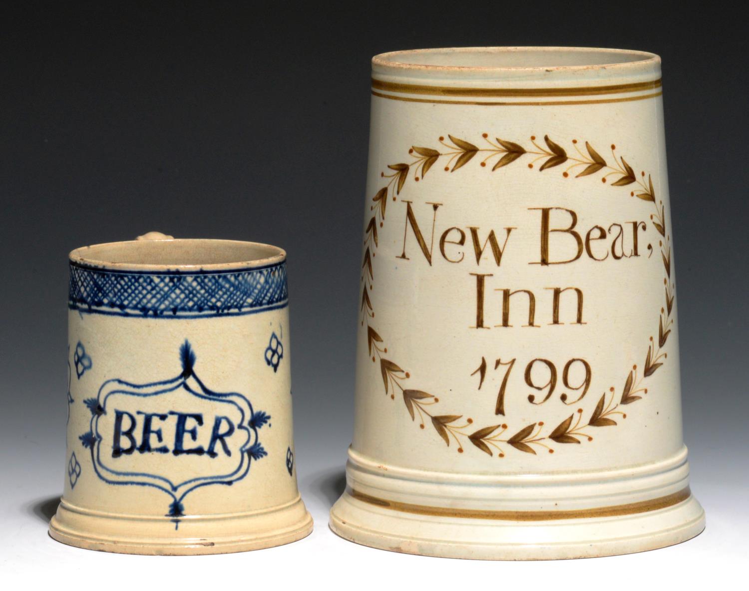 TWO PEARLWARE MUGS, ONE C1770, THE OTHER DATED 1799  the smaller painted in blue with a tablet